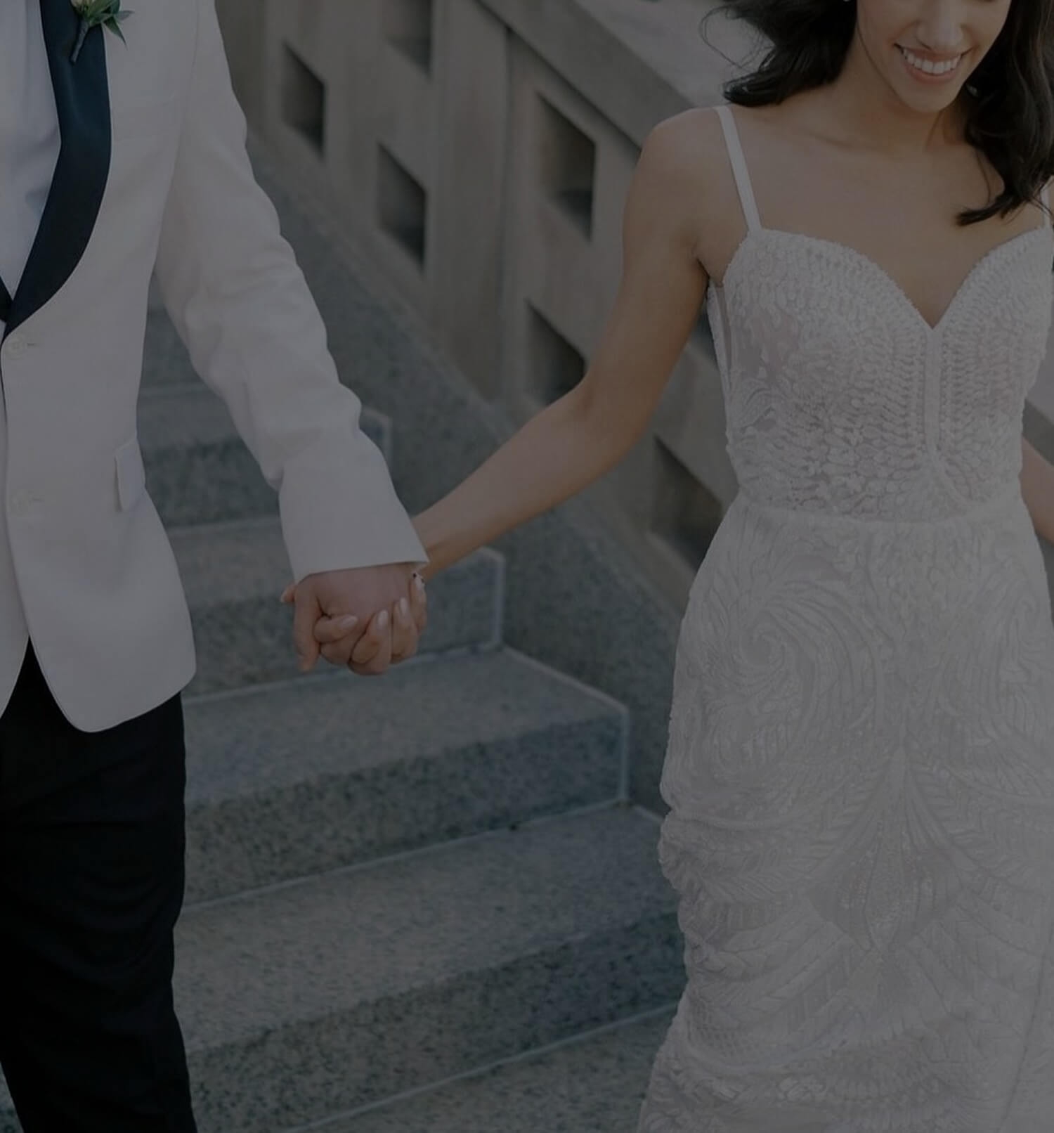 Сouple wearing a white gown and a white suit. Mobile image